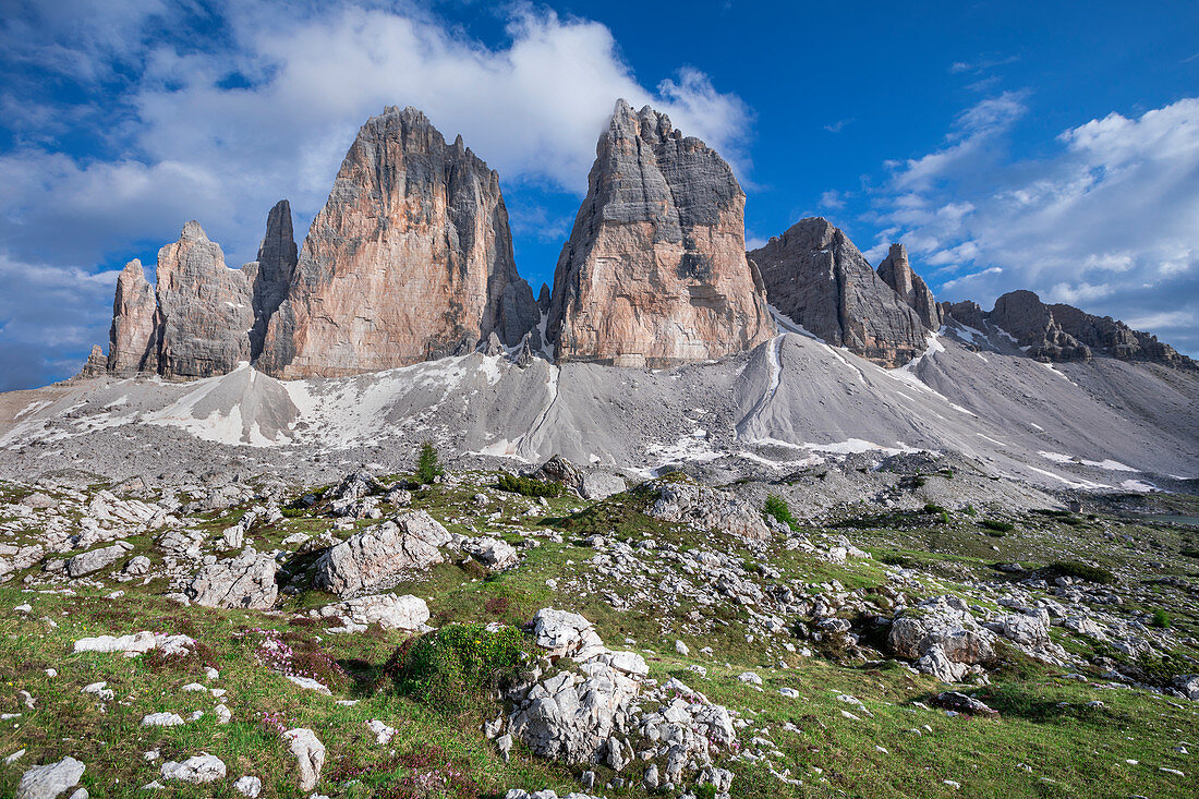 Below the Three Peaks on the north side with rocks and green meadows during the day, South Tyrol