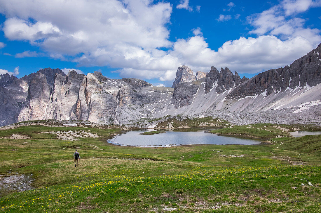 Man hiking on Lake Bödensee at the Drei Zinnen hut in the natural park of the Dolomites, South Tyrol