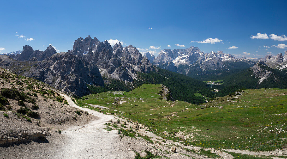 Hiking trail around the Three Peaks by day and blue sky in summer, South Tyrol