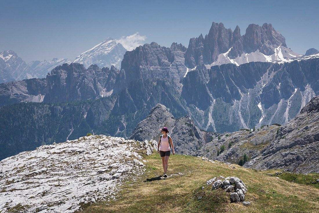 Woman hikes to Cinque Torri in the Dolomites, South Tyrol