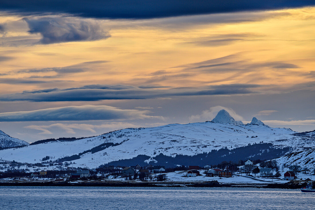 Bad weather clouds over coast and snowy mountains, Napp, Lofoten, Nordland, Norway