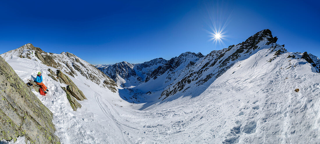 Panorama with woman on ski tour takes a break, Steintalspitzen, Stubai Alps, Tyrol, Austria