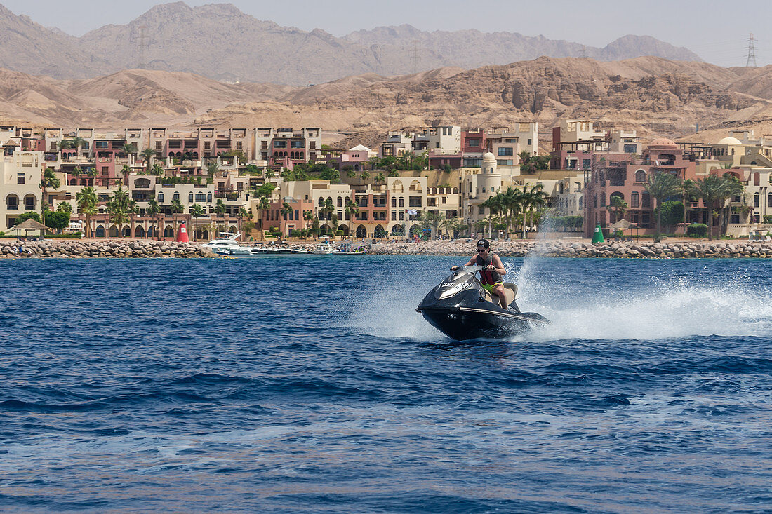 Tourist drives jet ski Tala Bay, Jordan
