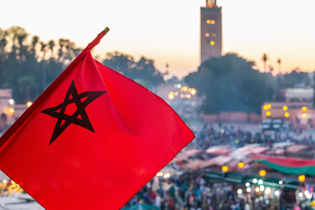 Die marokkanische Flagge weht über dem Djemaa El Fna in Marrakesch, Marokko