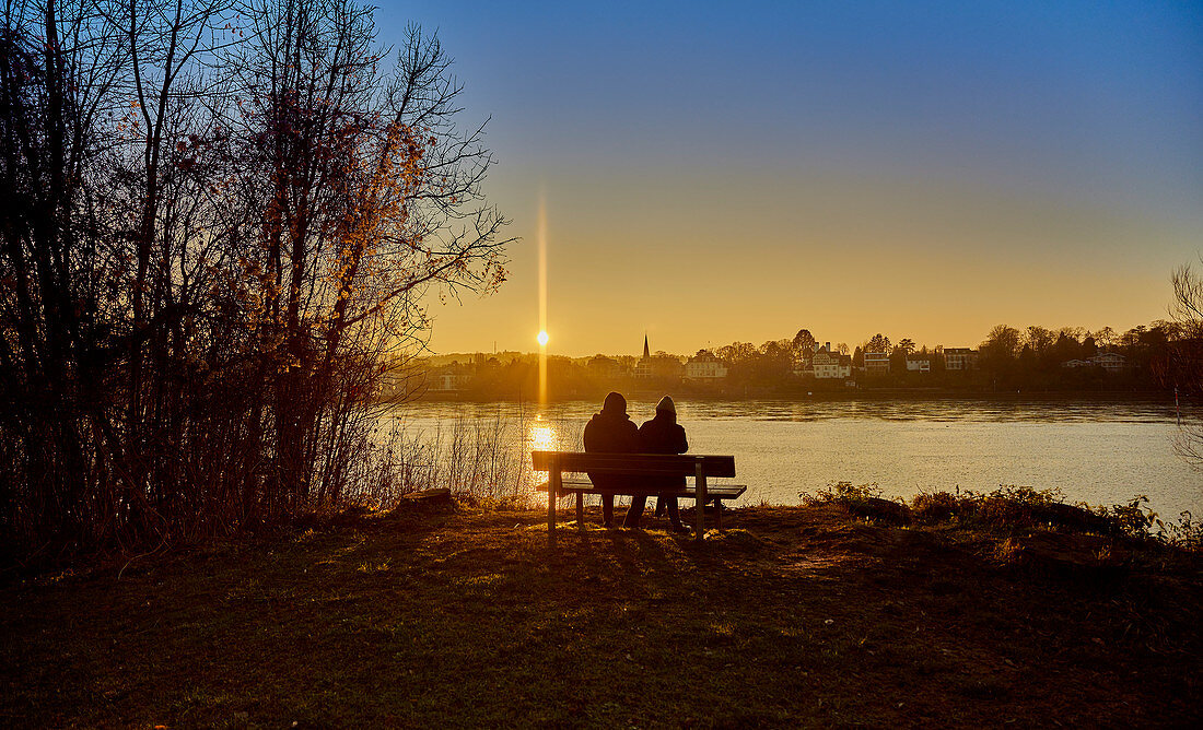 Menschen in der Abendsonne am Rhein, Deutschland