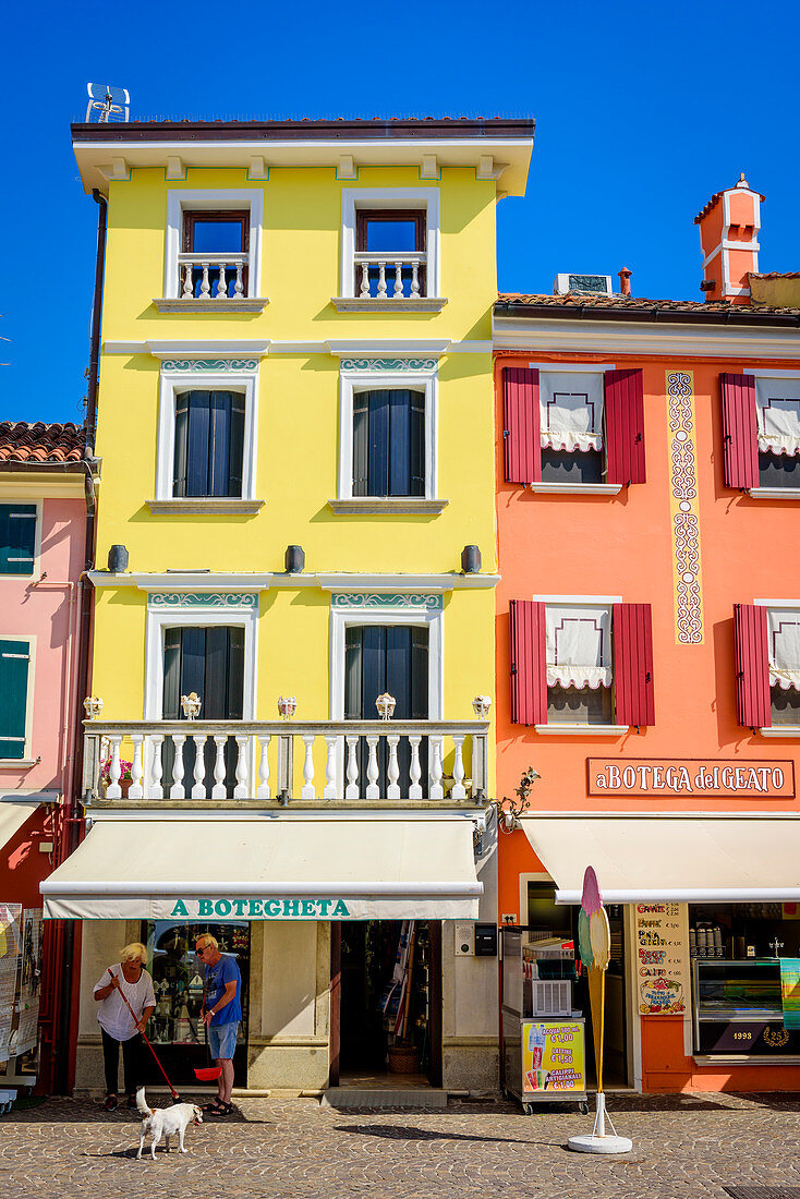 Shop and colorful house facades in Caorle, Veneto, Italy