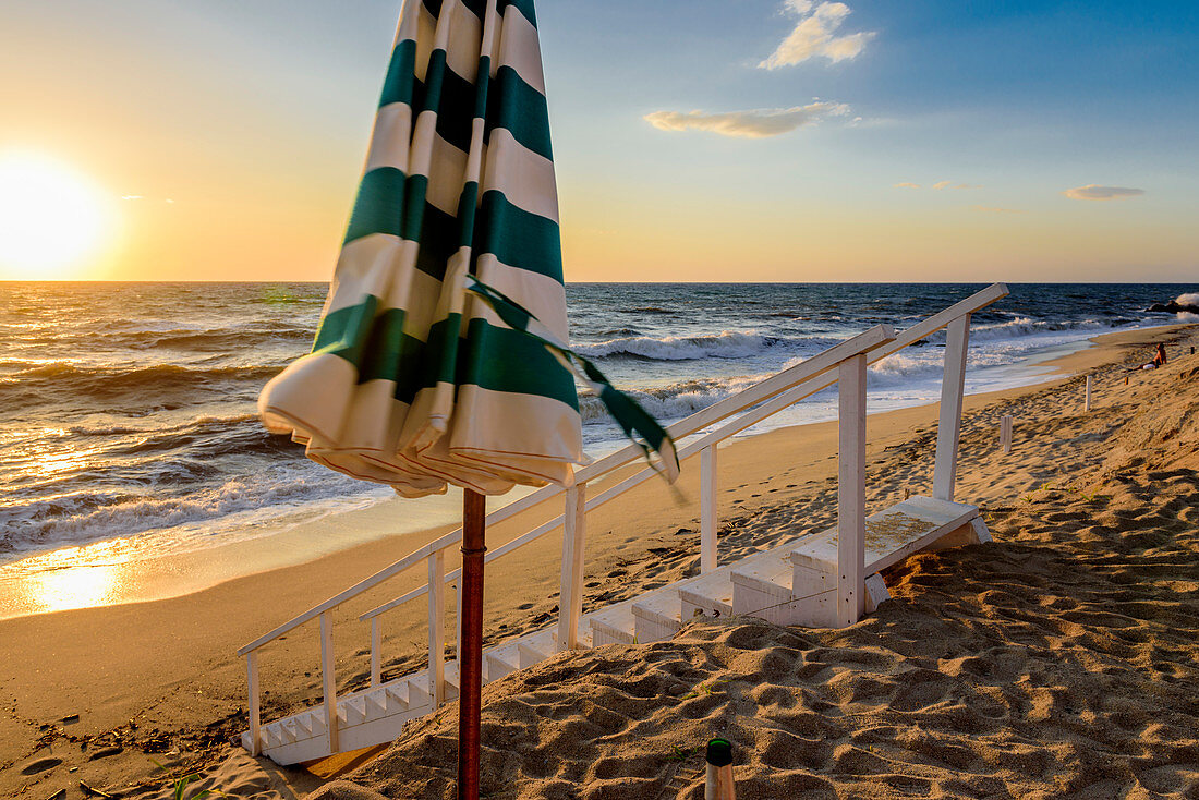 Sunset on the beach in front of the Stromboli, Calabria, Italy