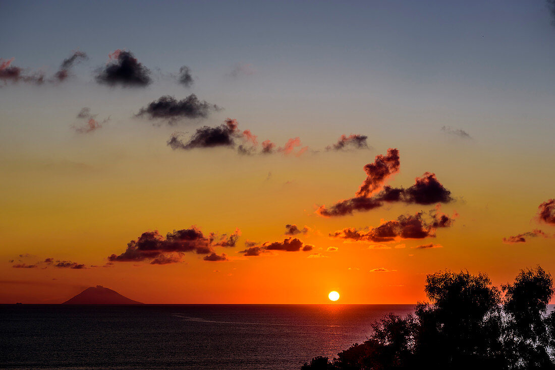 Sunset on the beach in front of the Stromboli, Calabria, Italy