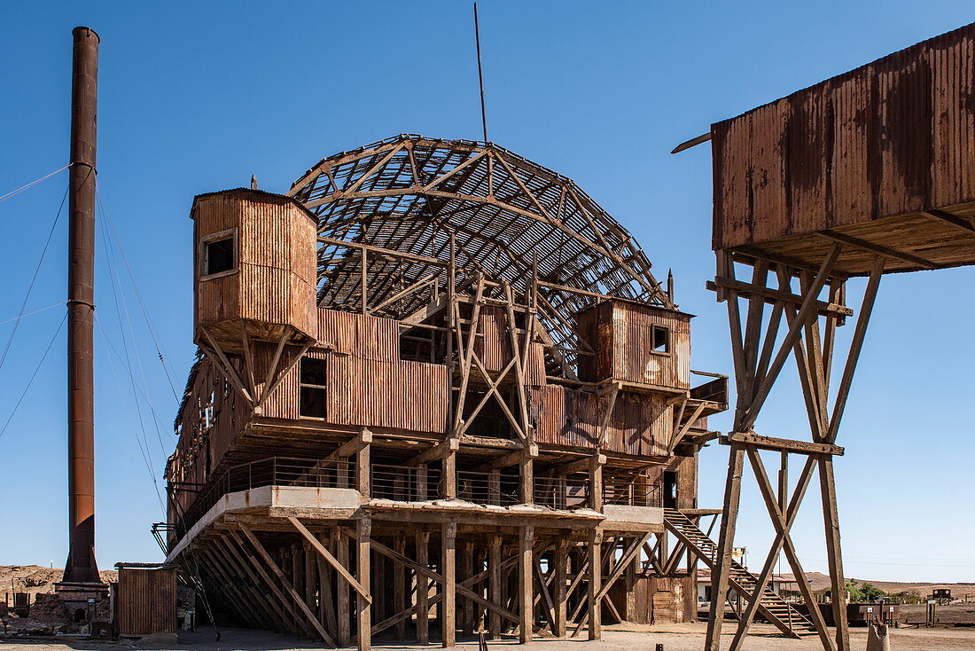 The skeletal remains of the Humberstone and Santa Laura saltpeter processing plant are rusting in the dry desert landscape, near Iquique, Tarapaca, Chile, South America