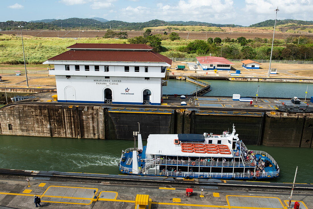 A tour boat pulls into one of the Miraflores locks on the Panama Canal, near Panama City, Panama, Central America