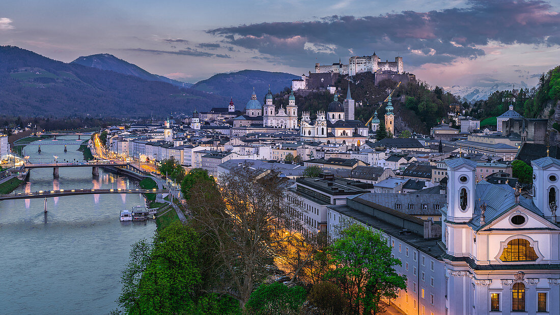 View of the illuminated city of Mozart and a great view of the Hohensalzburg Castle in Salzburg, Austria