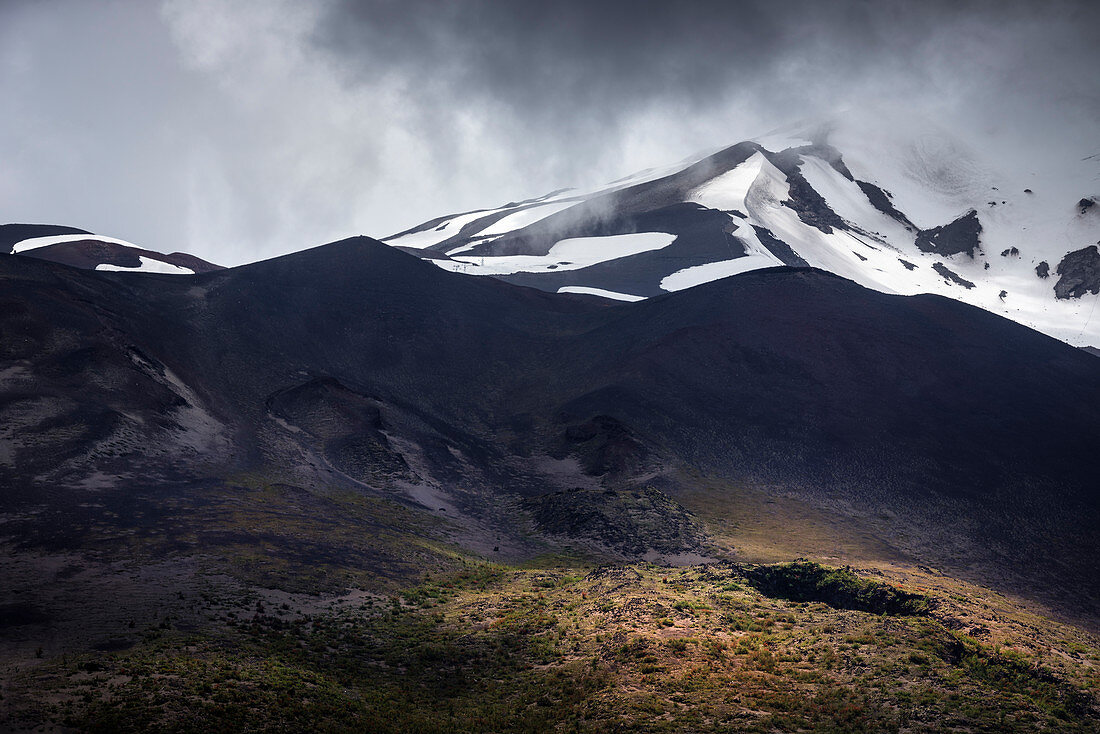 View to the cloud-covered summit of the Osorno volcano, Region de los Lagos, Chile, South America