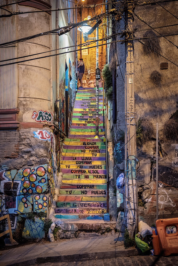 colorful stairs, young loving couple, street art in the streets of Valparaiso, Chile, South America