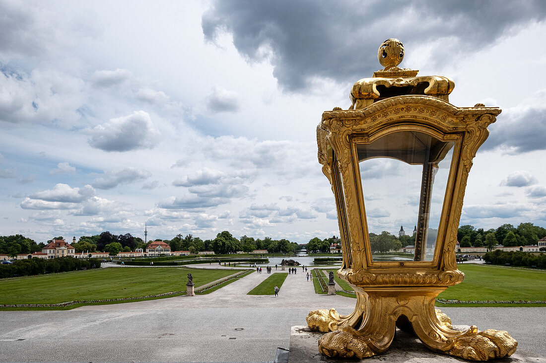 View of the square in front of the Nymphenburg Palace, in the foreground a golden lamp, Munich, Bavaria, Germany, Europe
