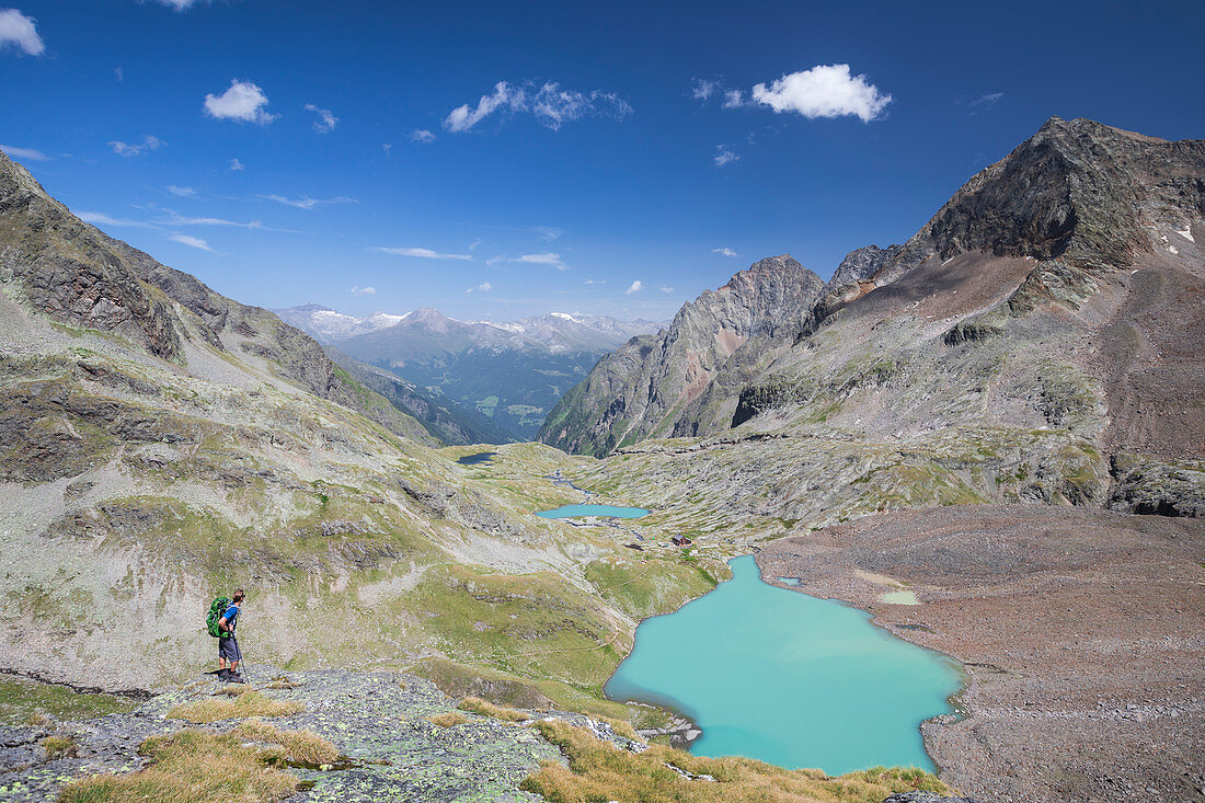 Hikers on the turquoise Gradensee at the Nossberger Hütte in the Gradental in the Hohe Tauern National Park, Austria