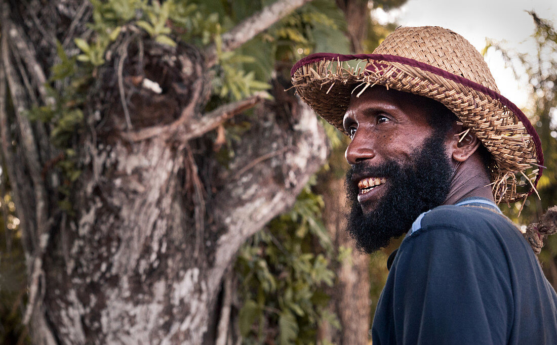 Papua New Guinea - November 12, 2010:  A smiling man with a beard is wearing a strawhat.