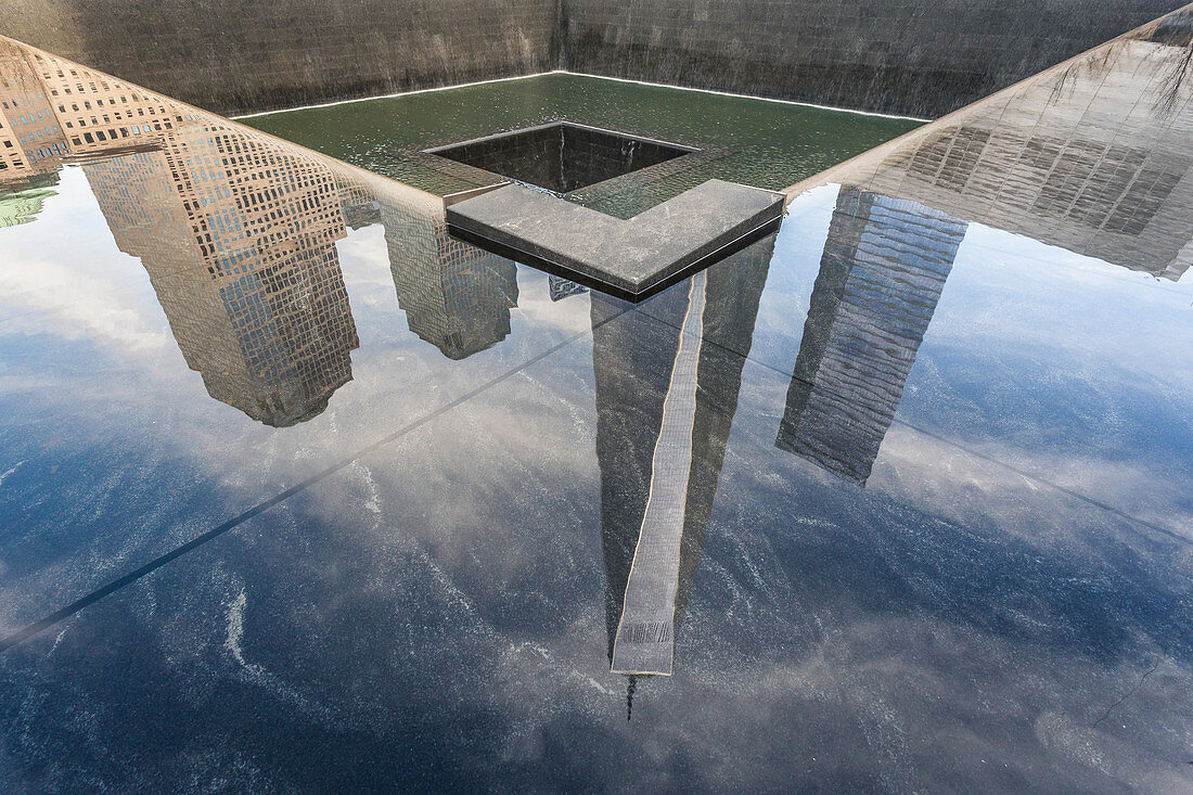 Reflection of the One World Trade Center in the 9/11 Memorial, New York City, USA