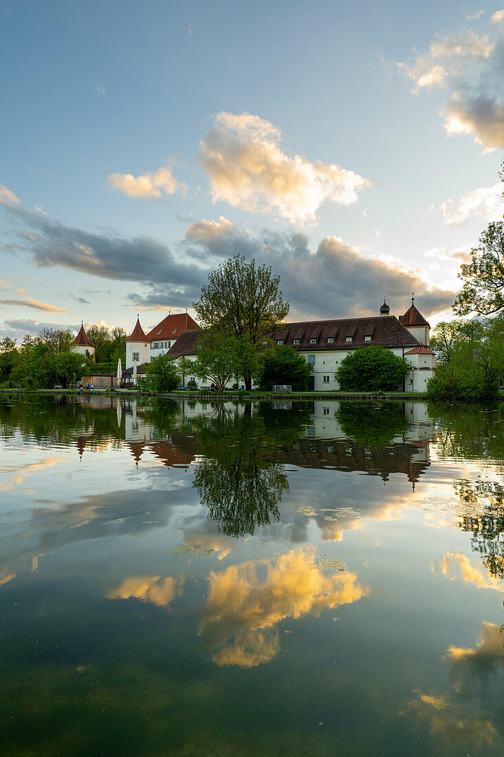 Evening view of the Blutenburg from the east, with reflection in the Würm, Munich, Bavaria, Germany