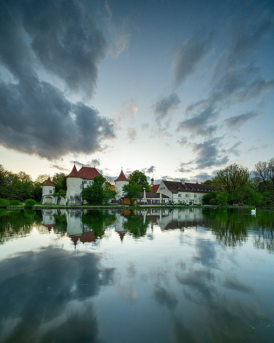 Evening view of the Blutenburg from the east, with reflection in the Würm, Munich, Bavaria, Germany