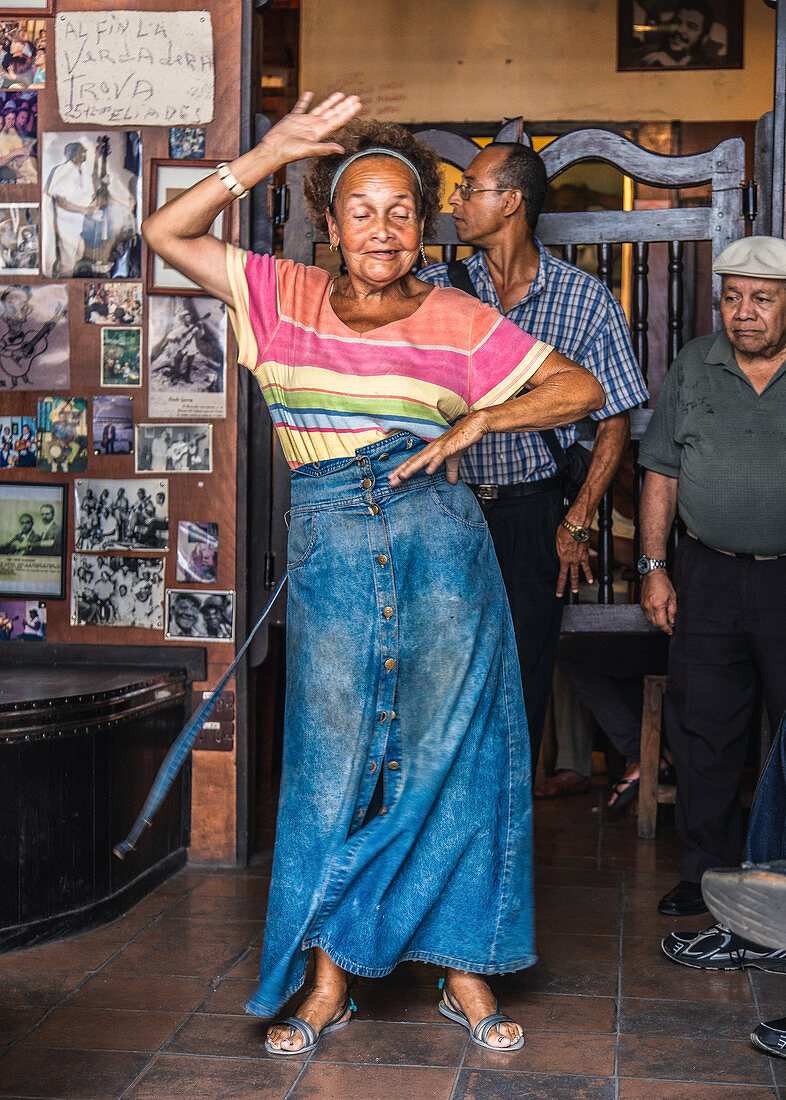 Elderly Cuban woman dancing in a bar in Santiago de Cuba, Cuba