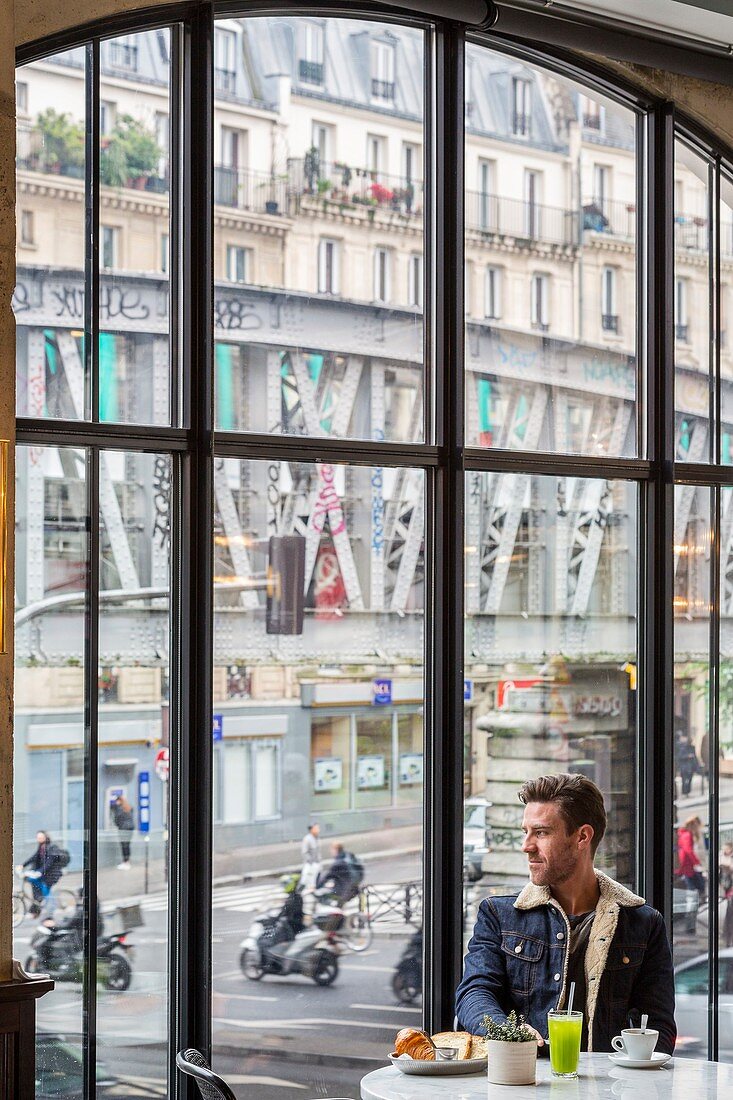 France, Paris, corner boulevard Barbes and Boulevard de la Chapelle, Brasserie Barbes opened in 2015, view on metro line 2, breakfast