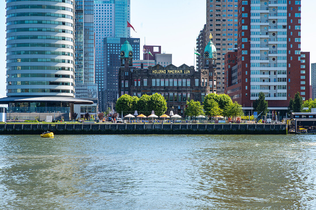 View over the New Meuse to the new district of Kop van Zuid. With the buildings World Port Center, Hotel New York and the Montevideo Tower. Rotterdam, The Netherlands, June 2020
