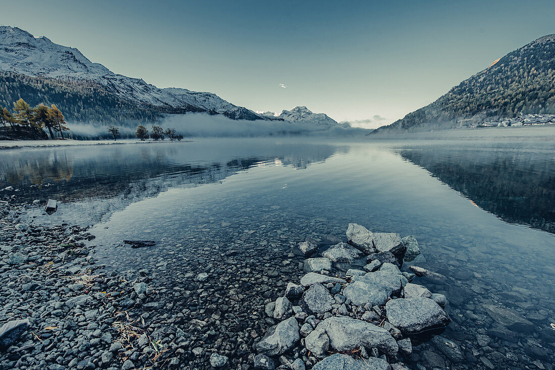 Lake Silvaplana at fog in sunrise, in the Upper Engadine, St. Moritz in the Engadine, Switzerland