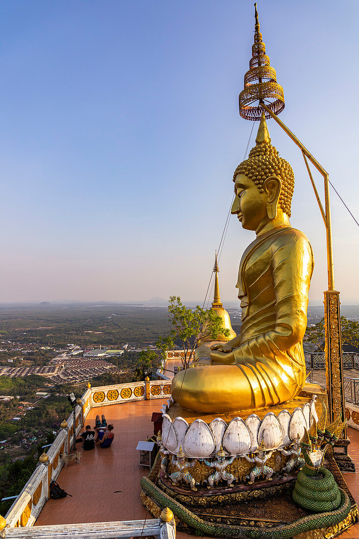 Buddha statue in the evening light on Tiger Cave Mountain, Tiger Cave Temple, Krabi Town, Thailand