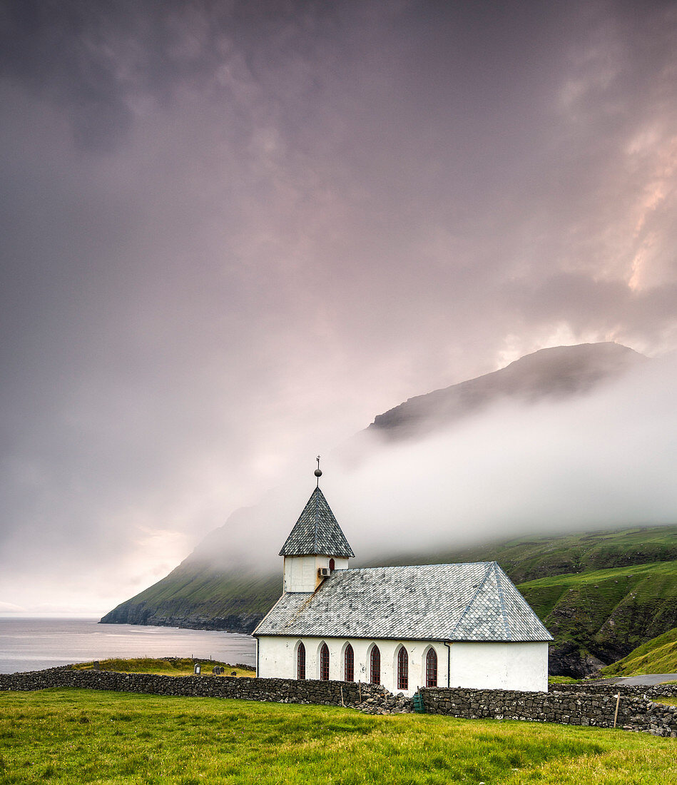 The church of Vidareidi at dusk, Vidoy Island, Faroe Island, Denmark, Europe