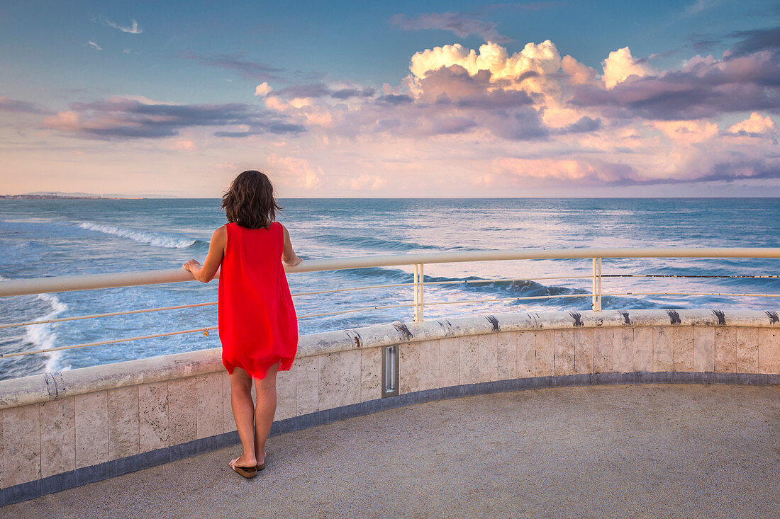 Mädchen beobachtet den Sonnenaufgang, Lido di Camaiore, Provinz Lucca, Versilia, Toskana, Italien, Europa (MR)