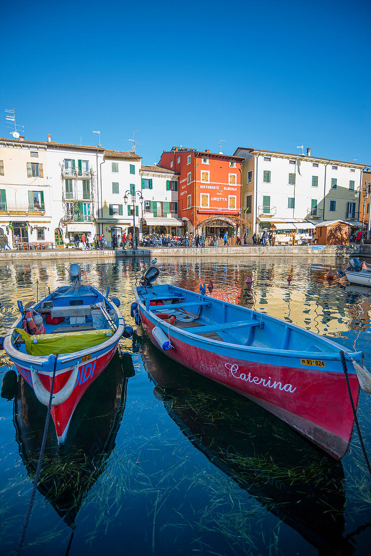 Lazise sul Garda, Verona province, Veneto, Italy, Europe. Two wooden boats in the harbour of Lazise 