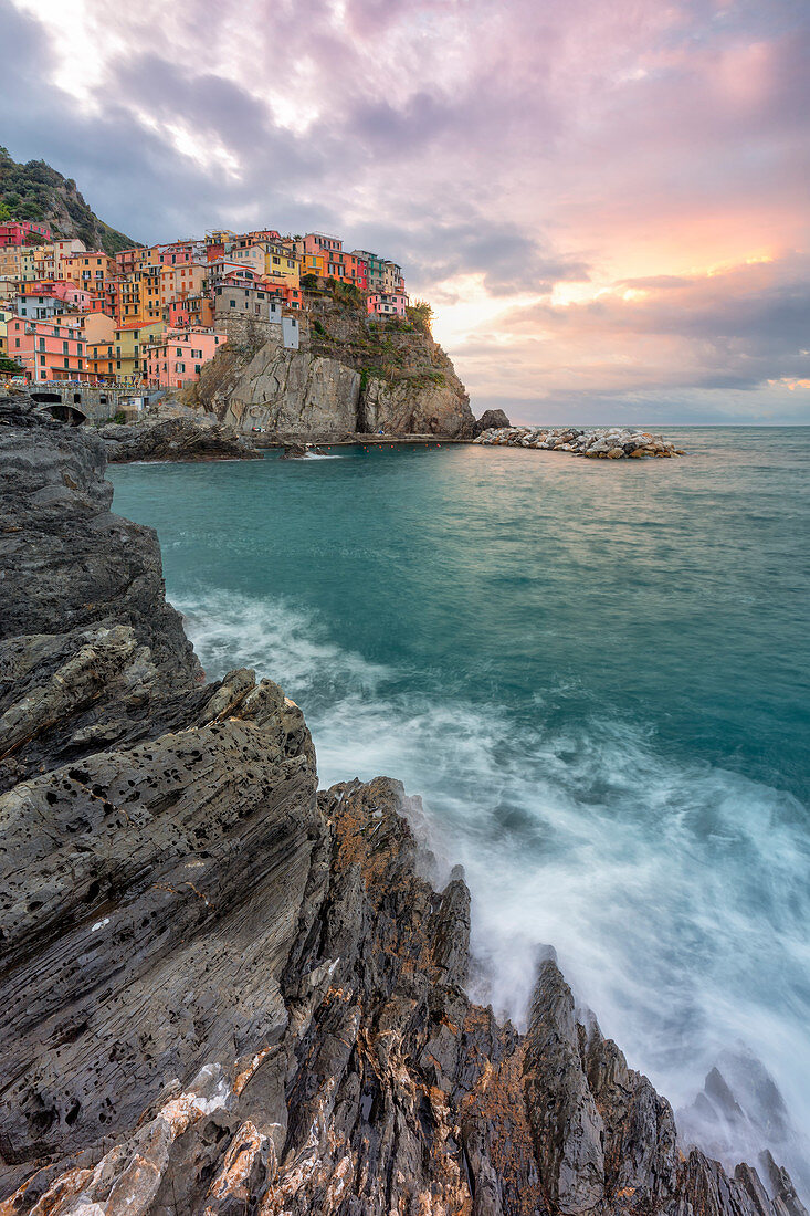 a coloured sunrise on cliffs of Manarola, National Park of Cinque Terre, Manarola, municipality of Riomaggiore, La Spezia Province, Liguria district, Italy, Europe