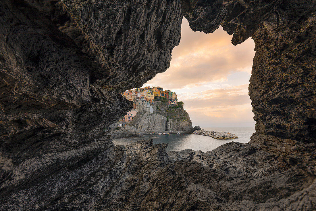 a magical sunrise seen from the inside of a small cave, National Park of Cinque Terre, Manarola, municipality of Riomaggiore, La Spezia Province, Liguria district, Italy, Europe