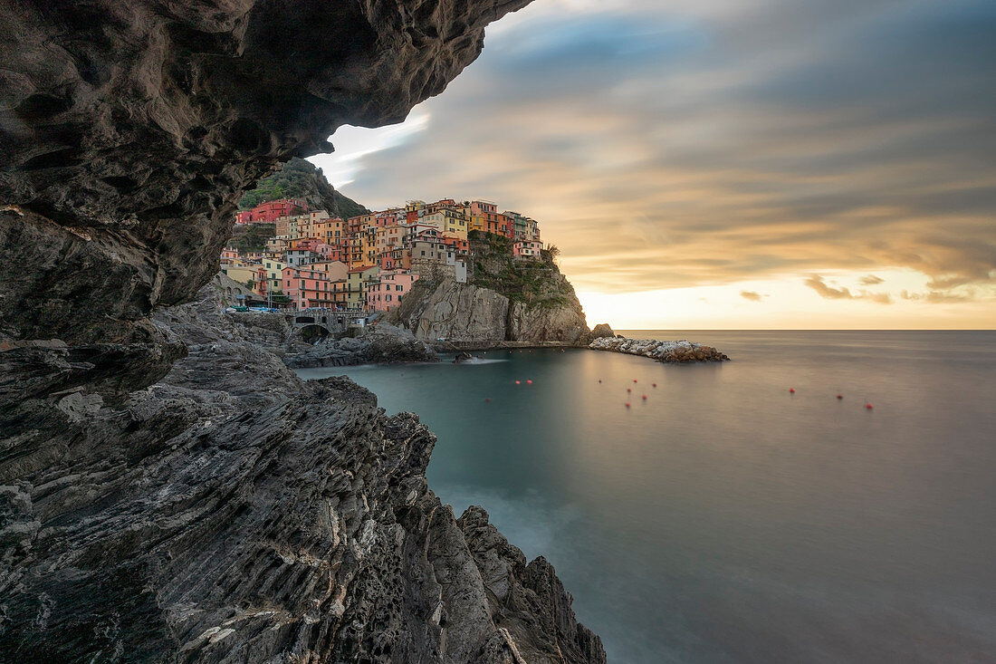 winter sunrise taken from the cave, town of Manarola, municipality of Riomaggiore, Cinque Terre, World Heritage Site, La Spezia province, Liguria district, Italy, Europe.