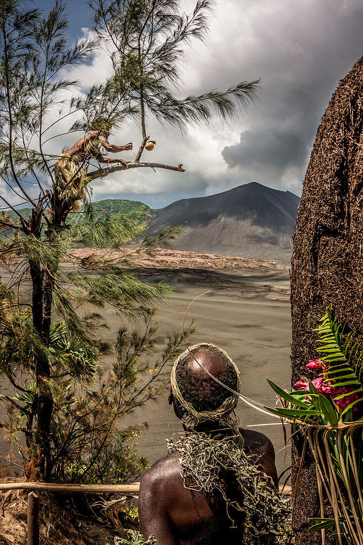 Locals on ash field in front of the Yasur volcano on Tanna, Vanuatu, South Pacific, Oceania