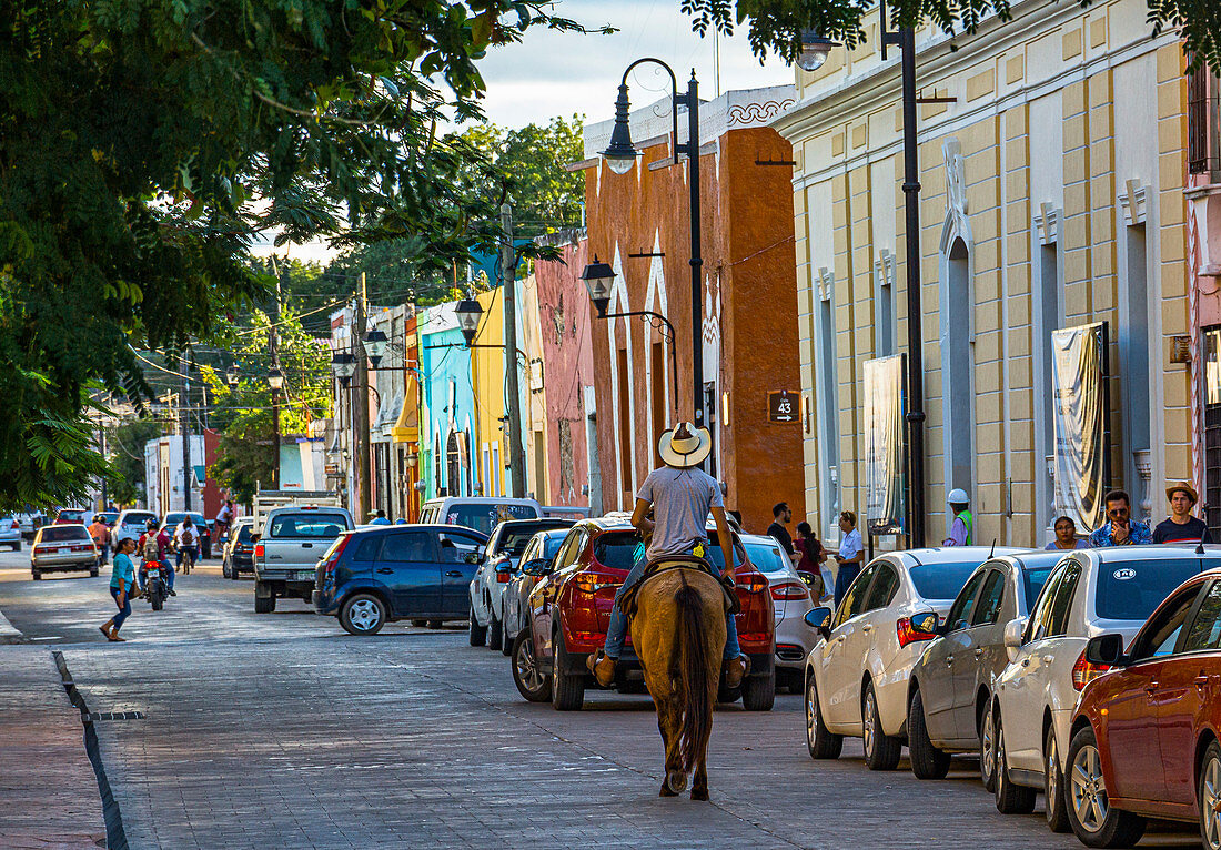 Riders on street at Parque Principal - city park in Valladolid, Yucatan Peninsula, Mexico