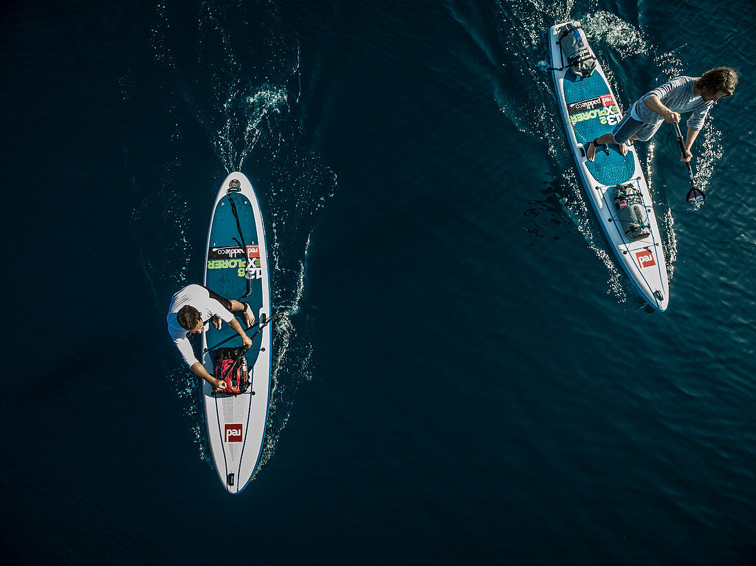 Aerial shot of two people on paddleboards.