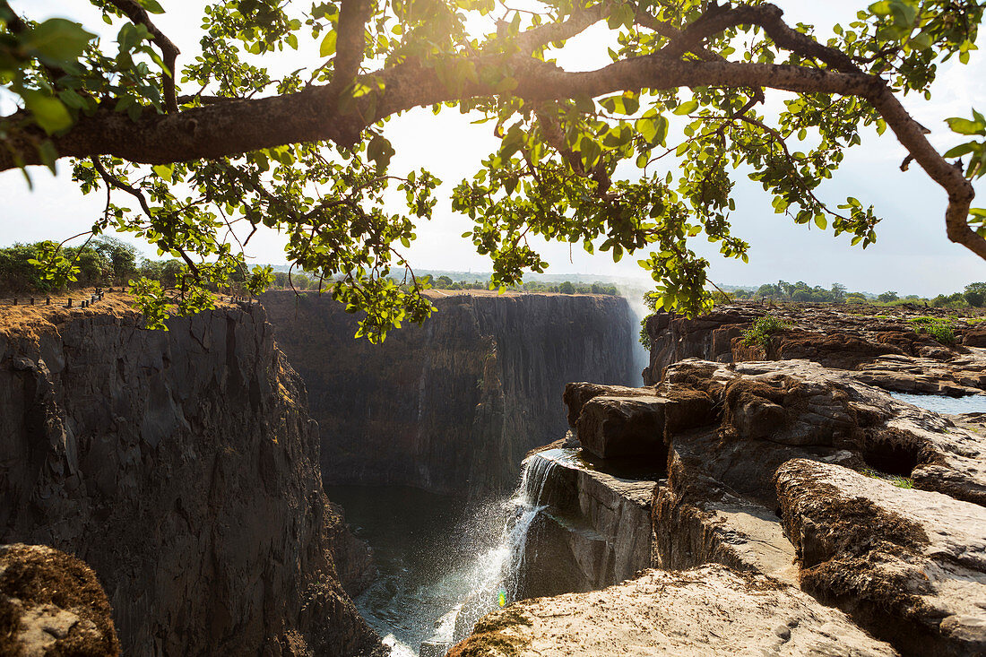Victoria Falls from the Zambian side, view of the vertical cliffs of the river gorge, and water flowing fast.