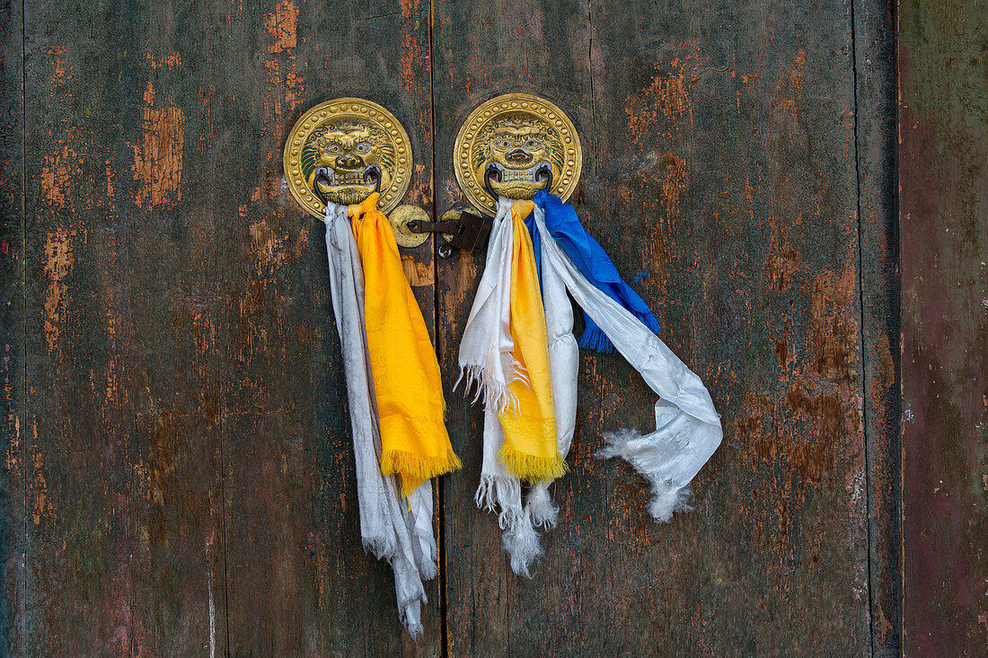 Door knockers with prayer scarves on the door to the Laviran Temple, part of the Erdene Zuu monastery complex in Kharakhorum (Karakorum), Mongolia, Mongolias largest monastery, (UNESCO World Heritage Site).