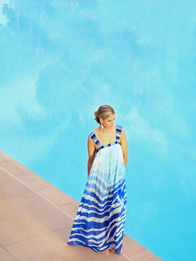 Caucasian woman standing at poolside