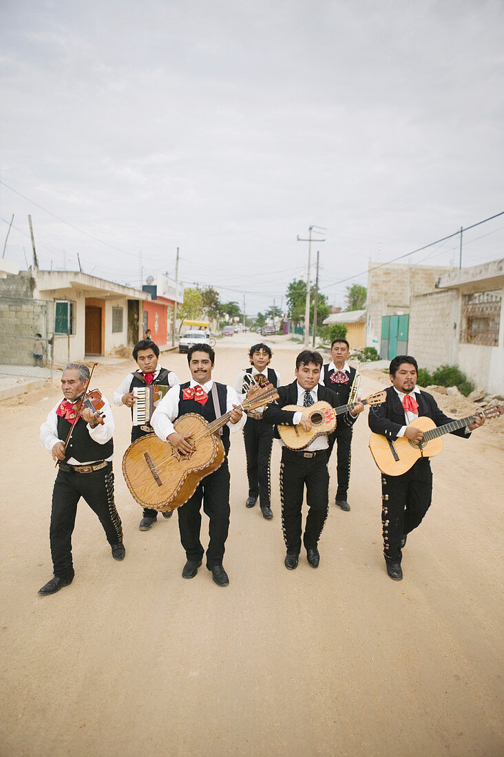 Mariachi band walking and playing their instruments