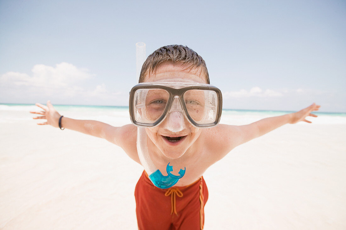 Young boy wearing a snorkel at the beach