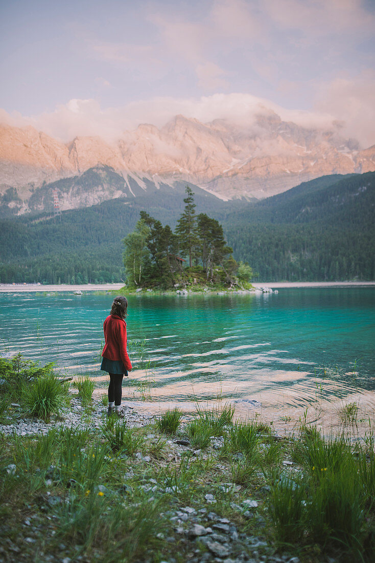 Germany, Bavaria, Eibsee, Young woman standing at shore of?Eibsee?lake in Bavarian Alps