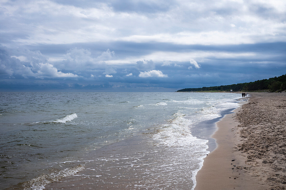 Dramatic beach panorama Baltic Sea on Usdeom cloudy sky, waves vacationers, Usedom, Mecklenburg-Western Pomerania, Germany