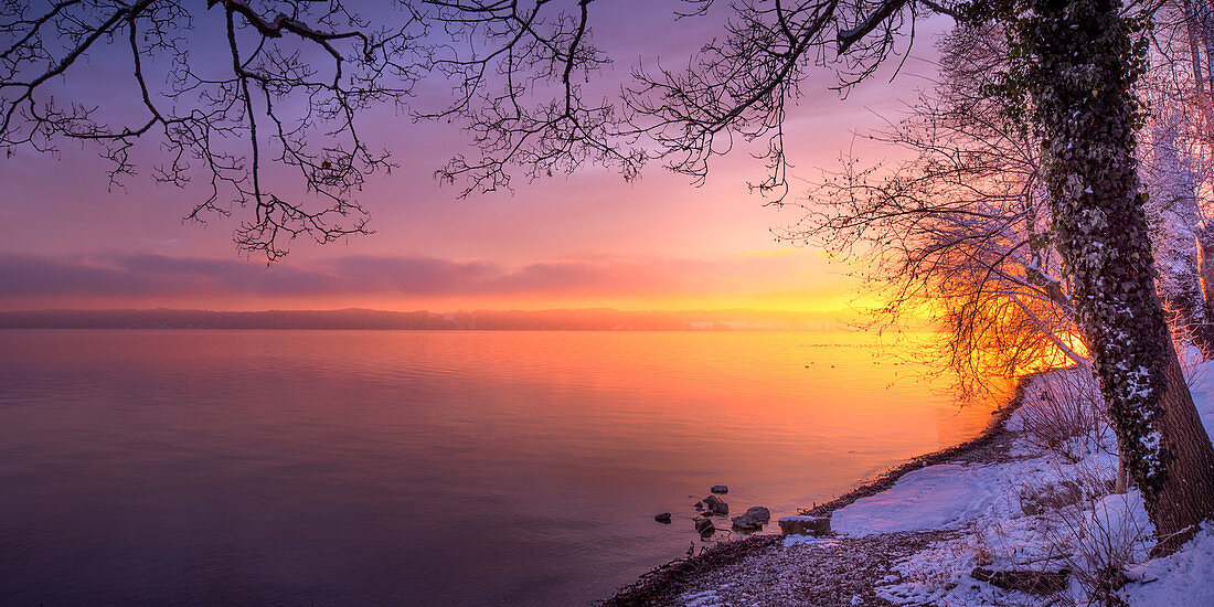 Winter morning with snow at sunrise on Lake Starnberg, Bernried, Bavaria, Germany