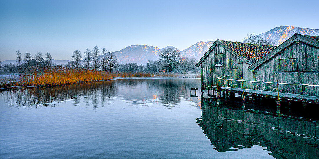Boat houses in the evening near Schlehdorf, Kochelsee, Bavaria, Germany