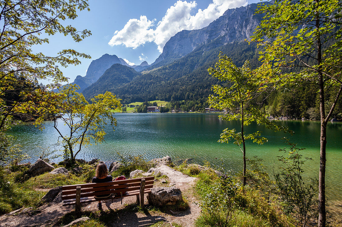 Woman on bench at Hintersee, Ramsau, Berchtesgadener Land, Upper Bavaria, Germany