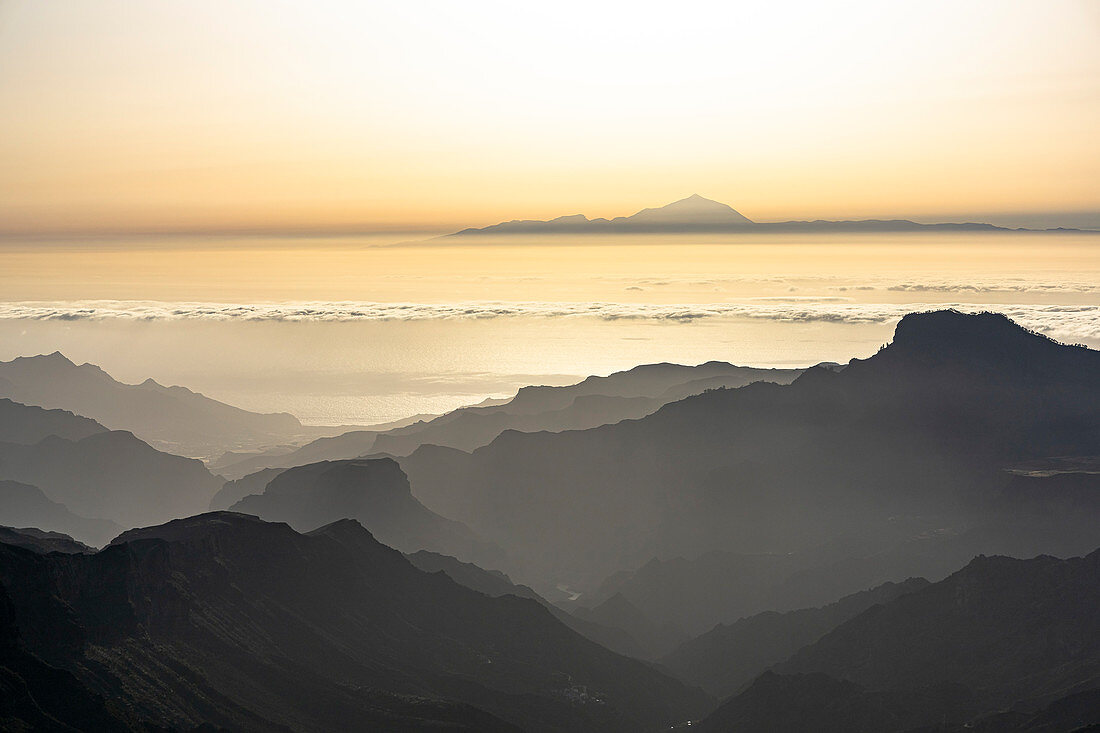 View from the &quot;Roque Nublo&quot; monolith in the high mountains of Gran Canaria (1813 m altitude) on Teide volcano (Tenerife) in the evening light, Spain