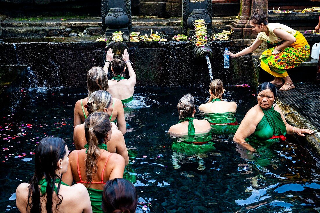 Foreign Visitors Bathing At The Tirta Empul Water Temple, Bali, Indonesia.