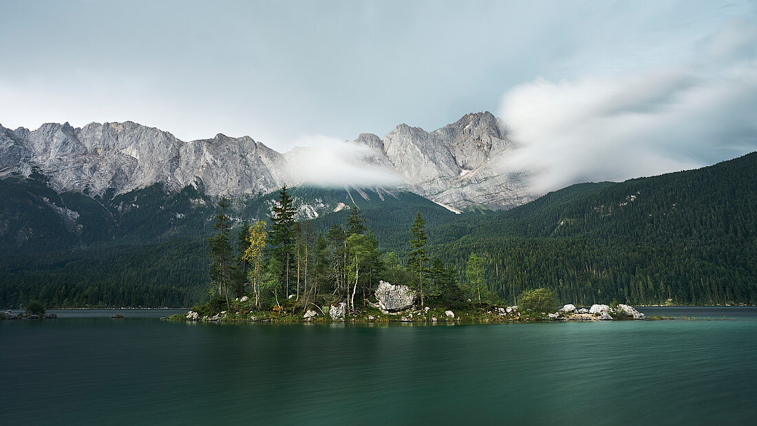 Shortly before a storm at Eibsee with a view of the Zugspitze massif (2962m), Bavaria, Germany.